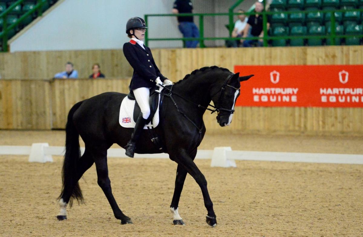 Woman riding a dark horse