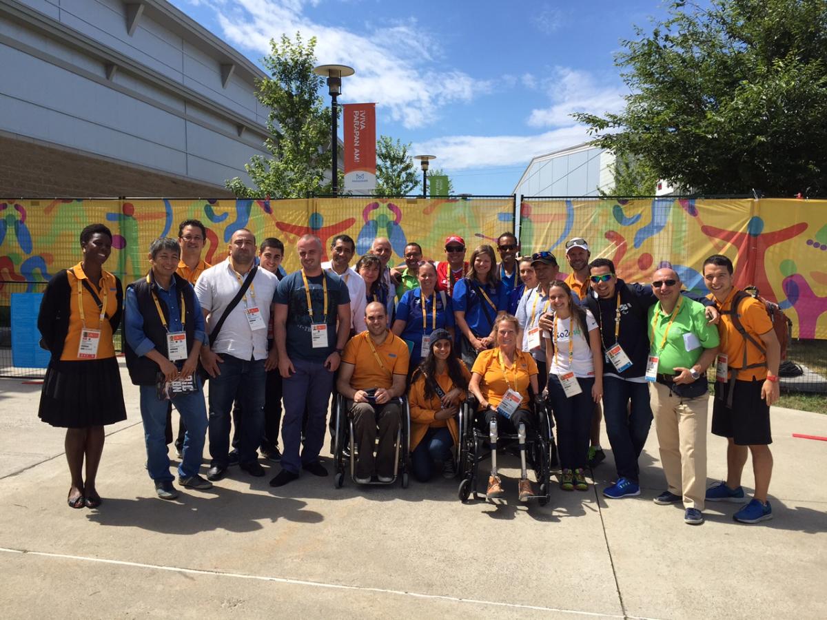 Group photo of people standing and in wheelchairs