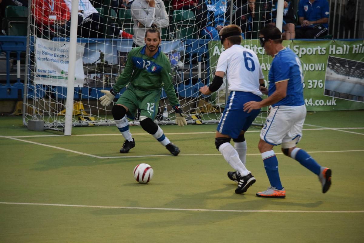 Blindfolded football player targeting the goal