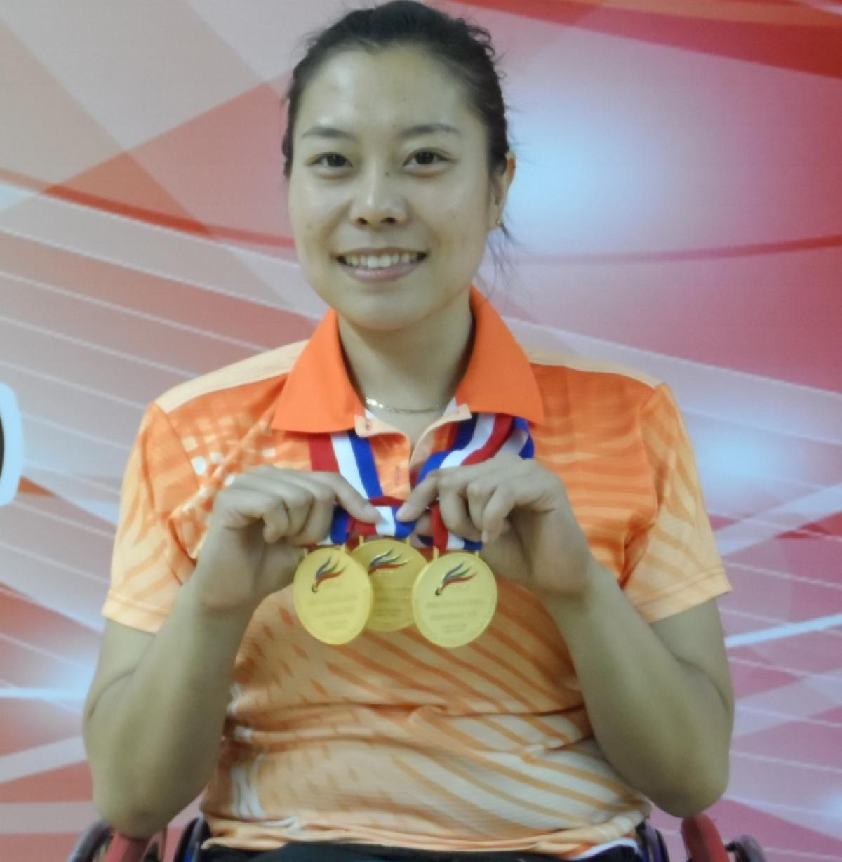 Woman holding medals