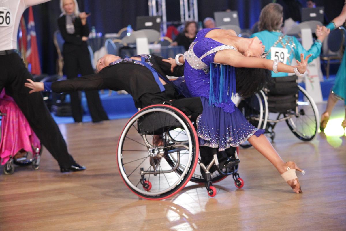 Man in wheelchair and woman performe.