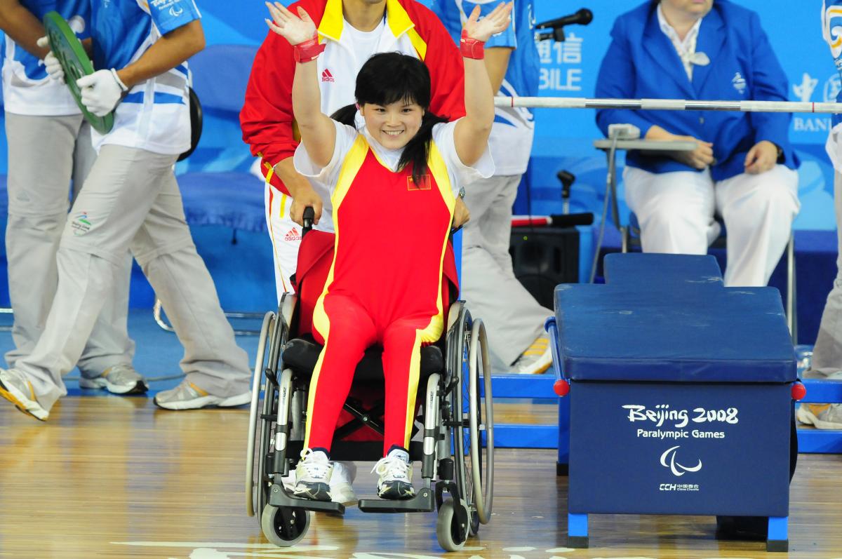 A Chinese powerlifter celebrates winning gold in powerlifting at her home Paralympic Games.