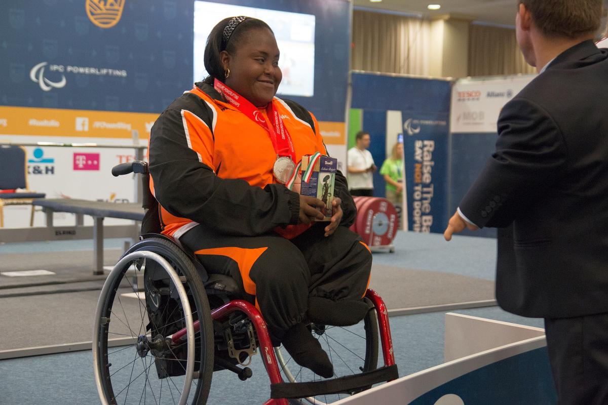 Woman in wheelchar with medal around her neck