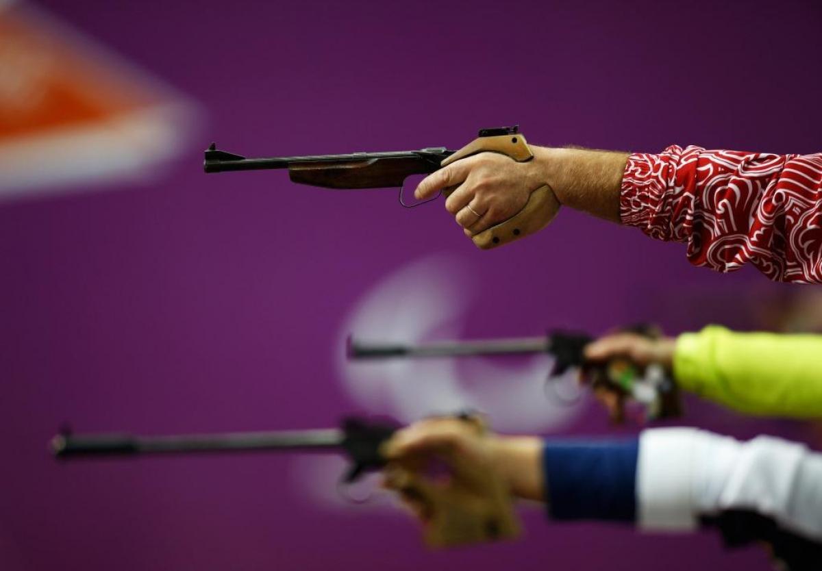 Competitors raise their pistols during the Mixed P4-50m Pistol-SH1 competition at the London 2012 Paralympic Games 