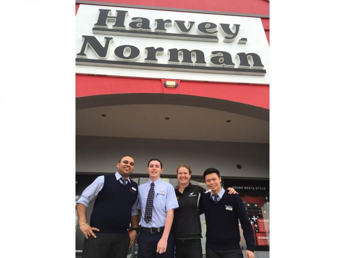 Fiona Allan, Chief Executive, PNZ, with members of the Harvey Norman's team.