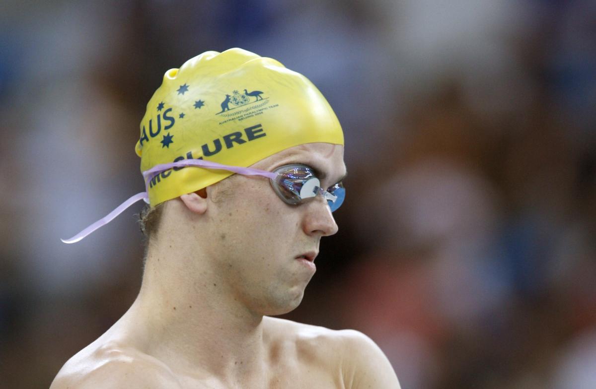 A visually impaired swimmer prepares for a race