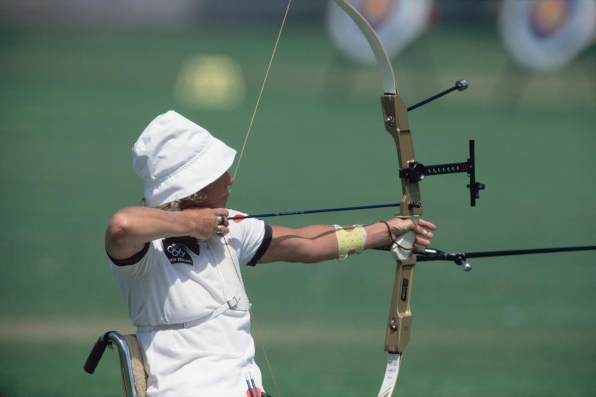 Woman in wheelchair doing archery