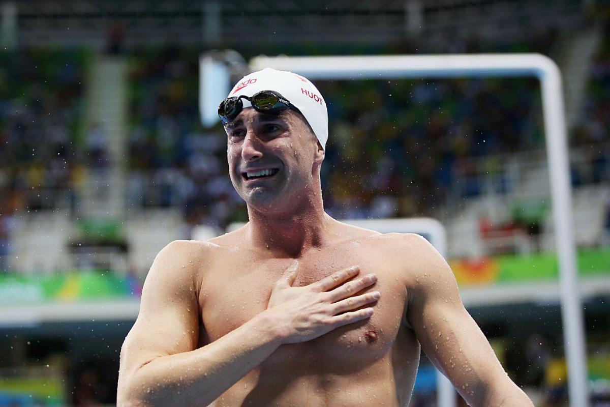 A swimmer is delighted with his victory.