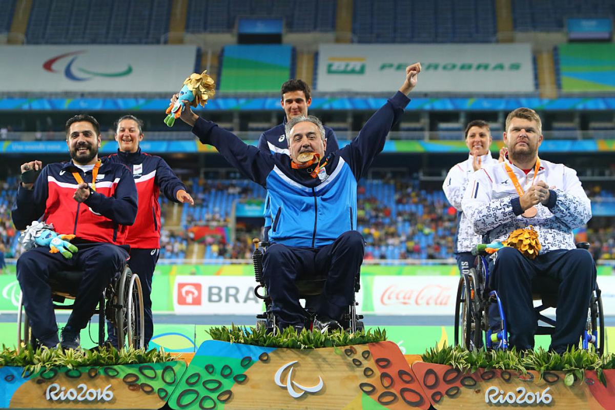 Gold medalist Zeljko Dimitrijevic of Serbia  poses on the podium at the medal ceremony for Men's Club Throw - F51