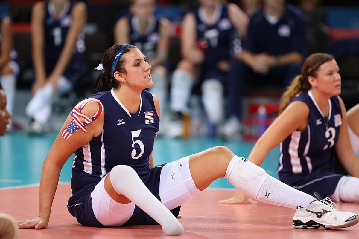 Woman sitting on a volleyball court