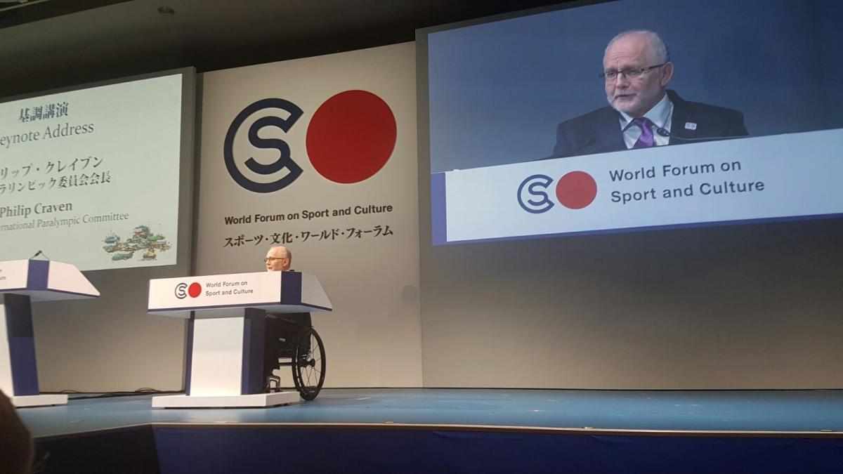 Sir Philip Craven - speech - Tokyo Man in wheelchair on stage giving a speech