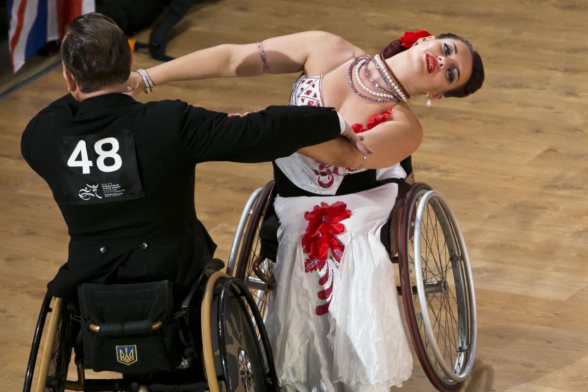 A man and woman in wheelchairs dancing