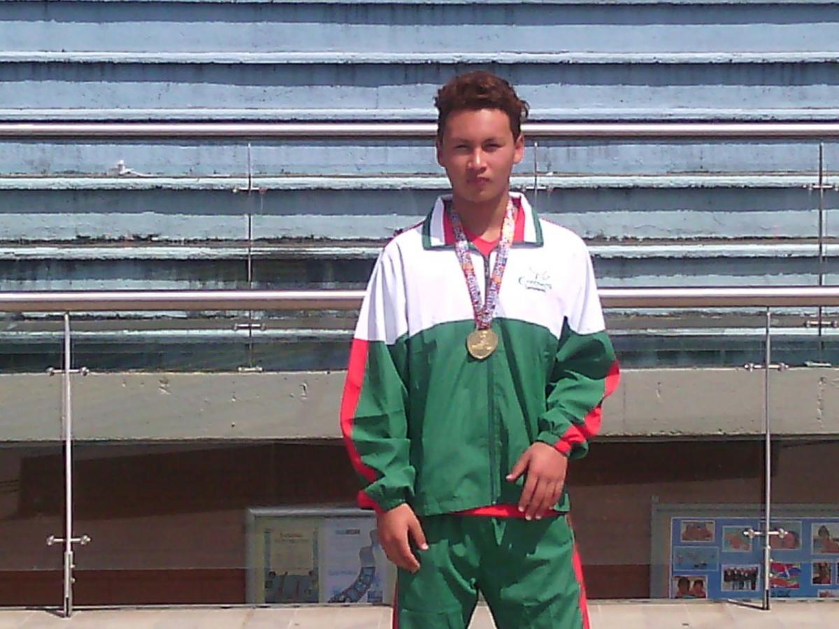 A swimmer poses with a medal