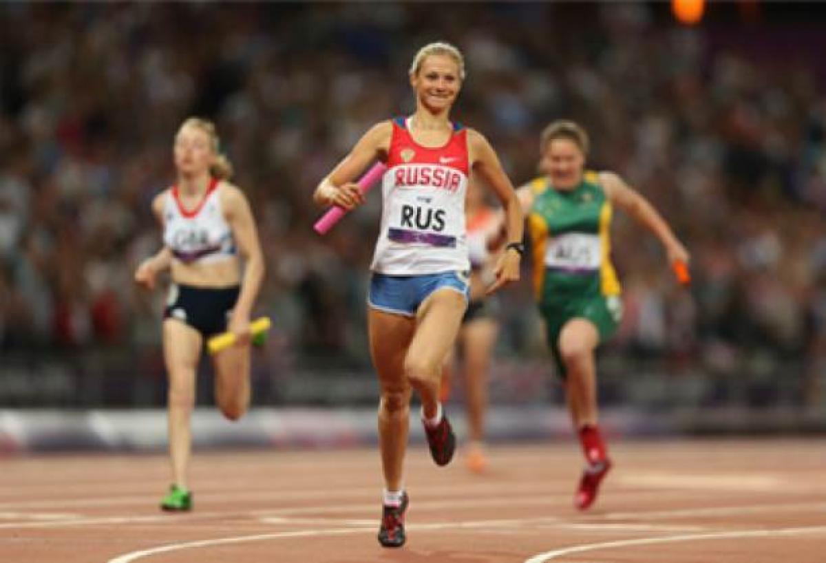 A picture of a woman running on a track 