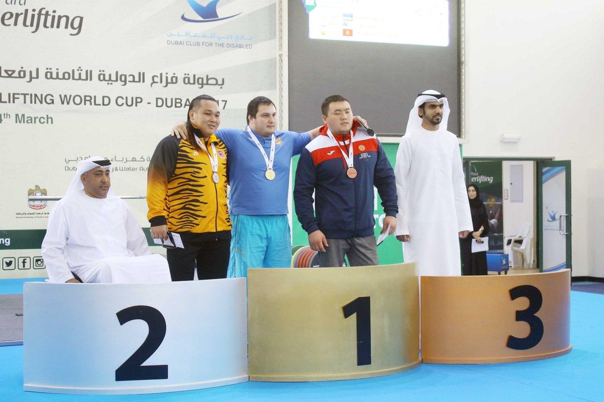 Three men on a podium