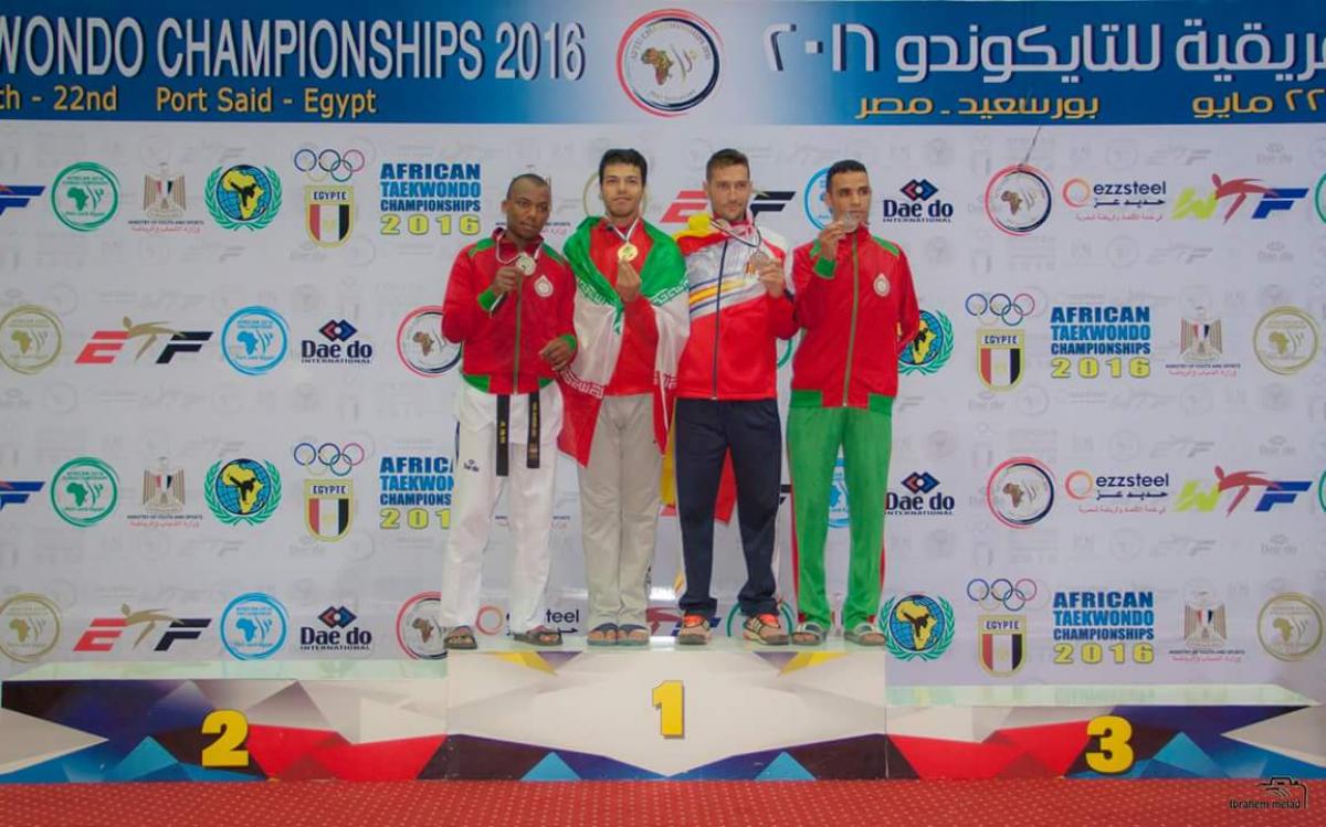 Four men stand on the podium