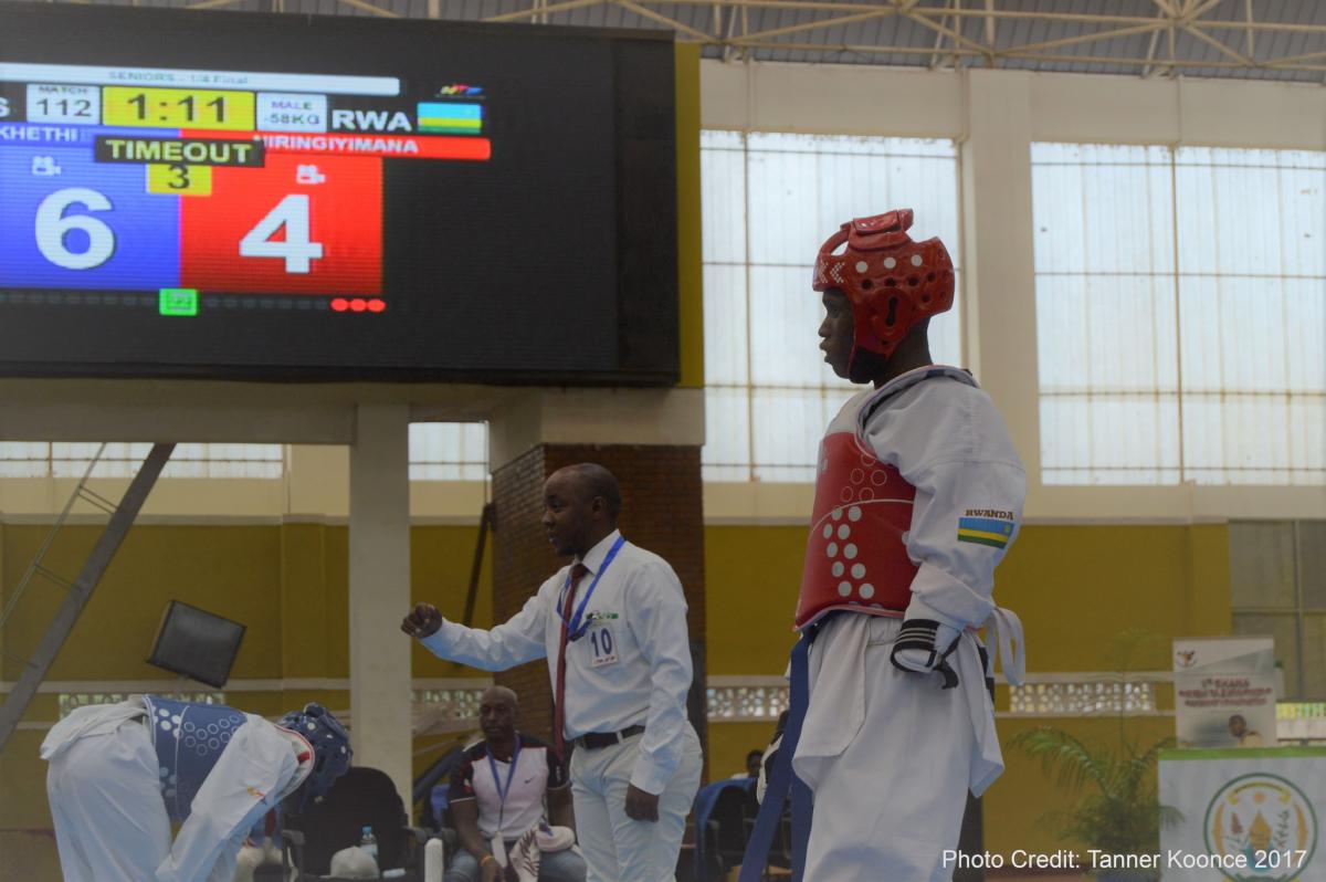 Man in taekwondo uniform at a competition