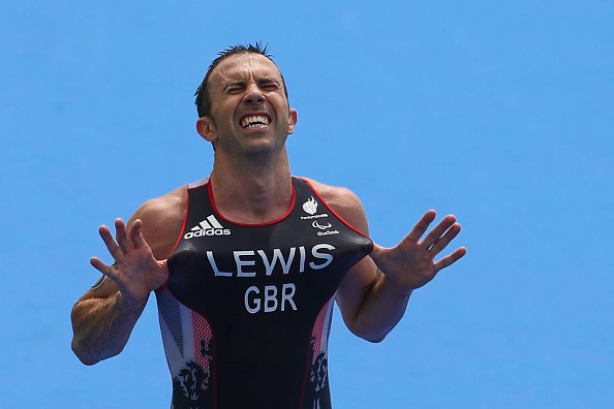 Male triathlete celebrates after winning race