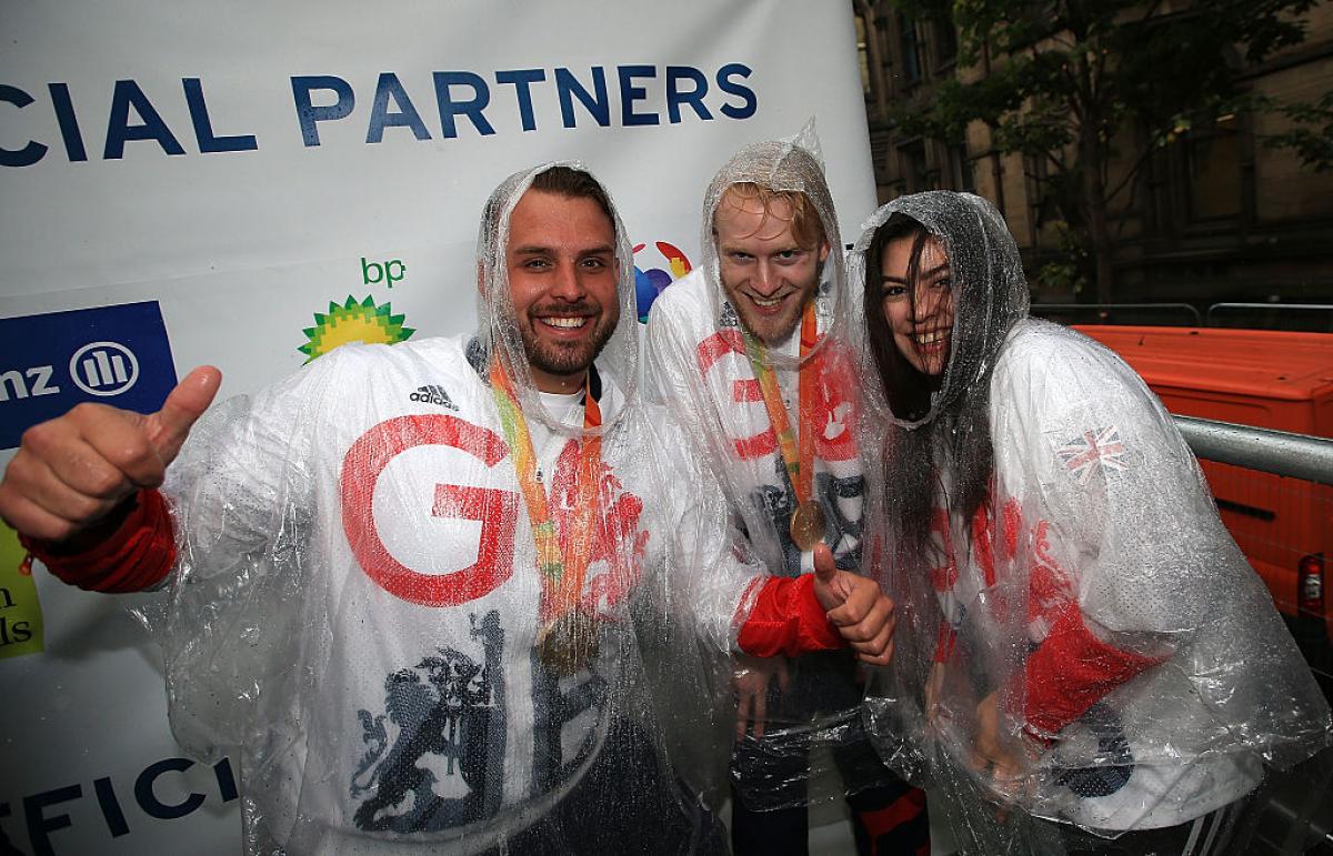 Julie Rogers smiles alongside Aled Davies and Jonnie Peacock at Rio 2016 victory parade