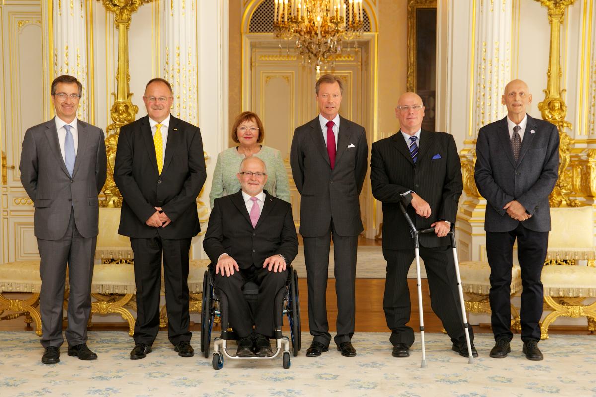 A group of people smiling for an official photograph