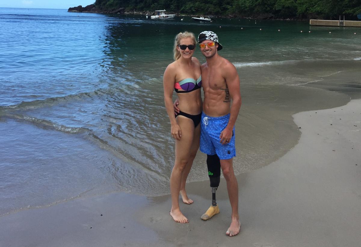 a man and a woman in swimsuits on a beach