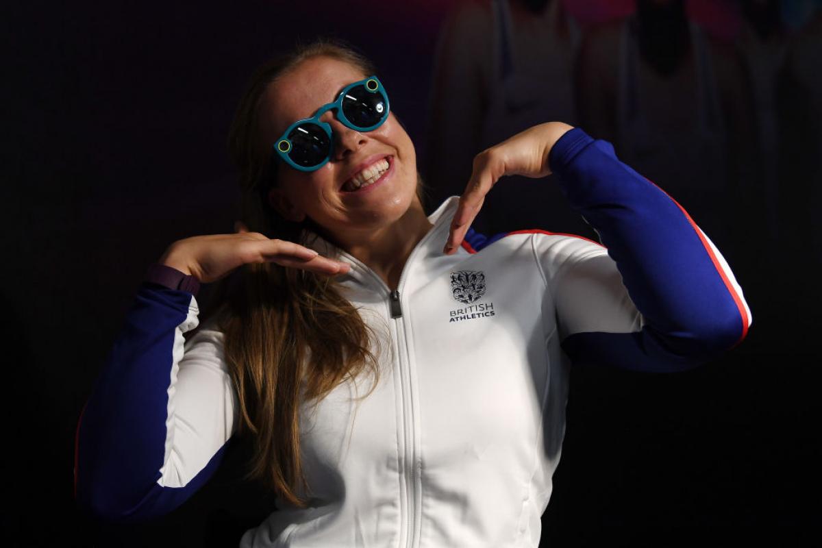 A girl in sunglasses poses for the camera