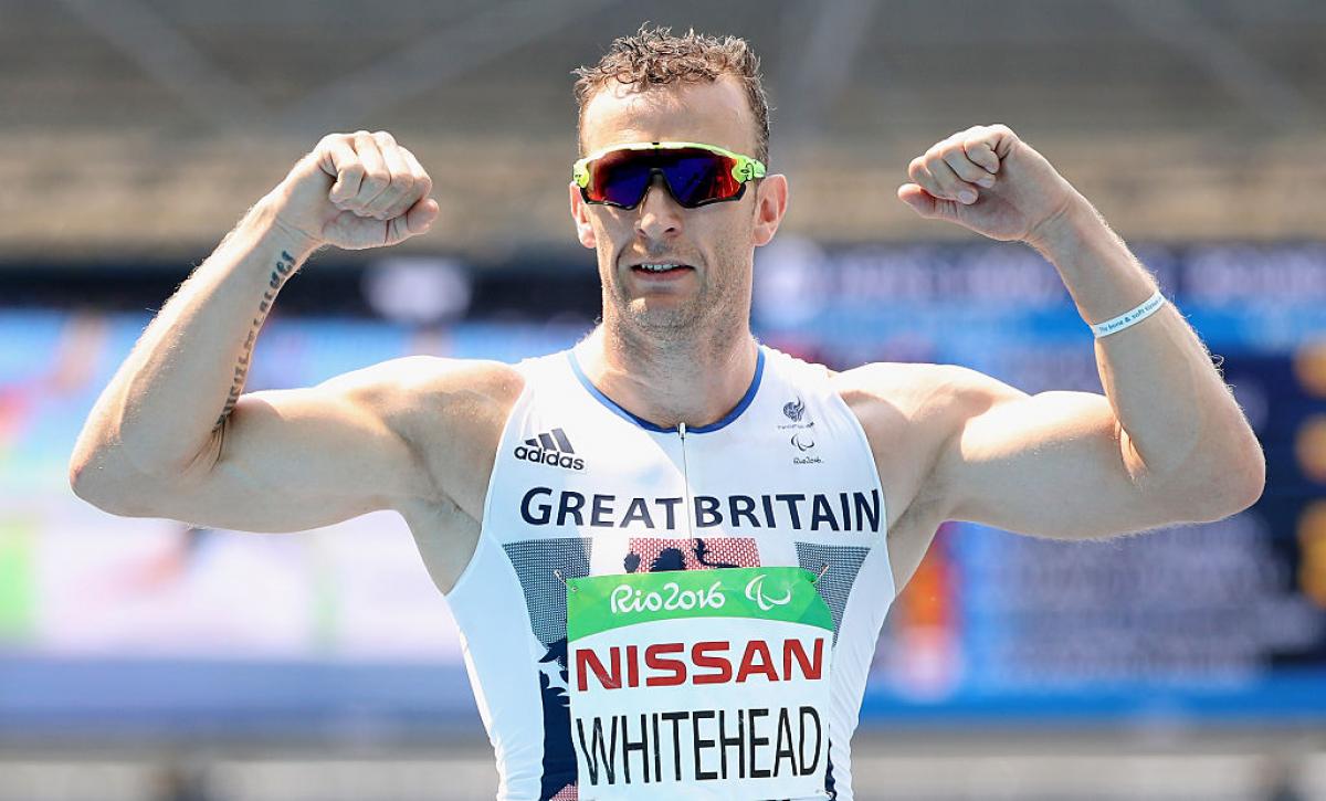 Richard Whitehead - Rio 2016 a man raises his arms to show off his muscles