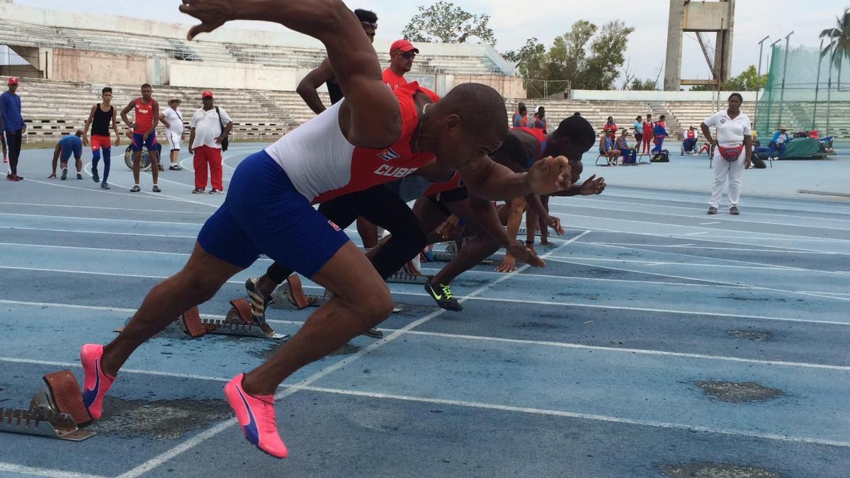 a group of Para sprinters spring from the blocks