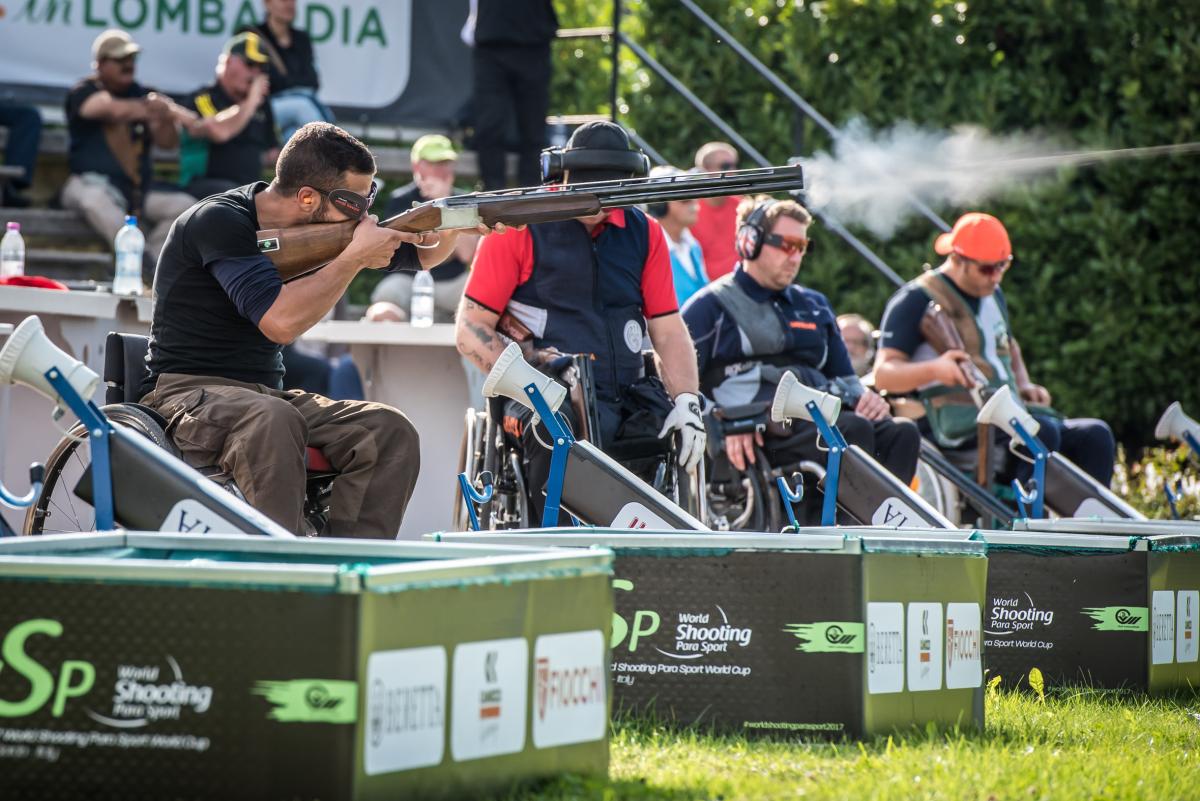 Man shoots a shotgun during a competition 