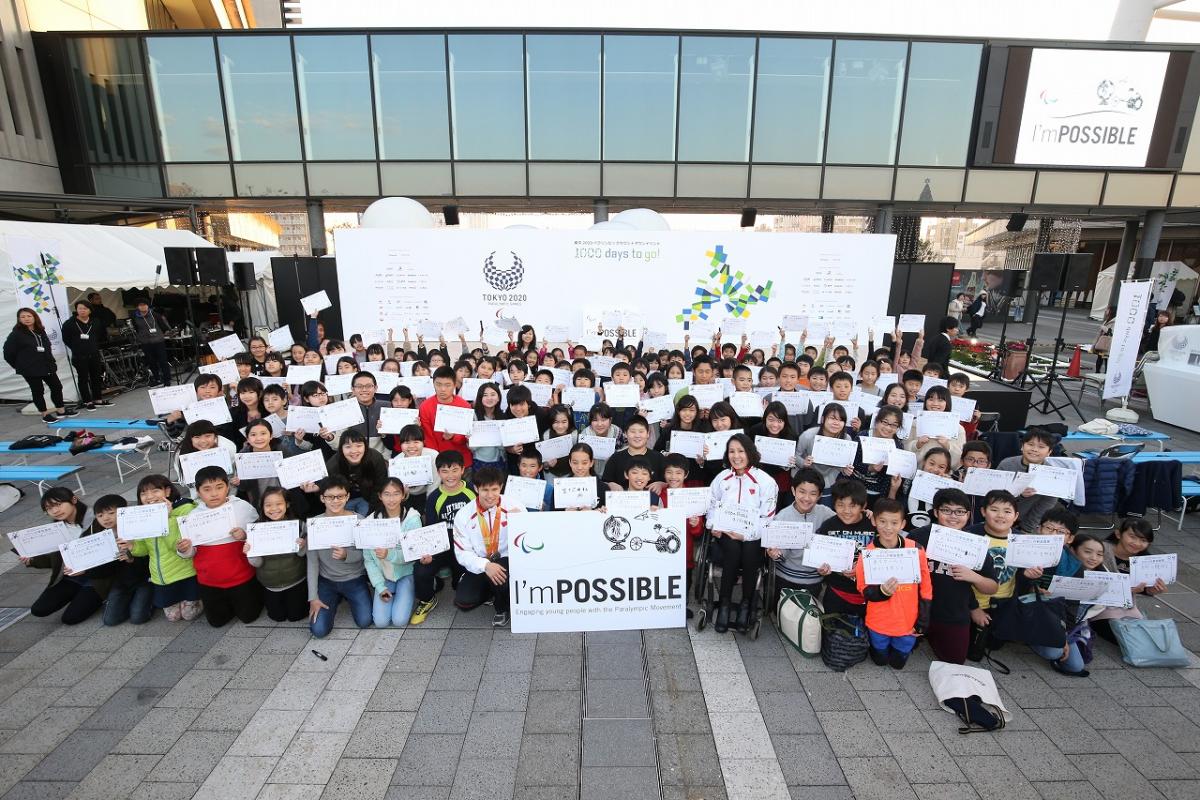 a group of schoolchildren holding up signs