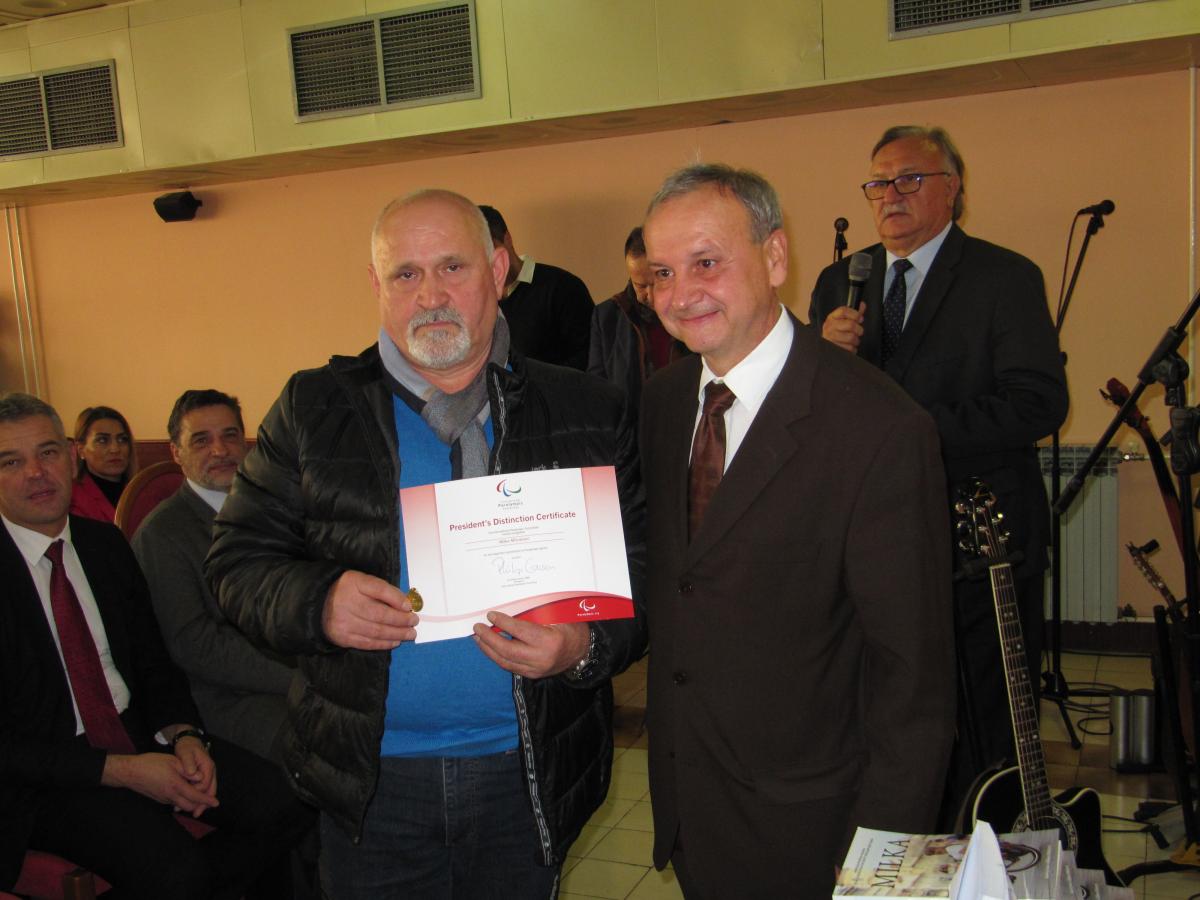 Two men holding up a certificate