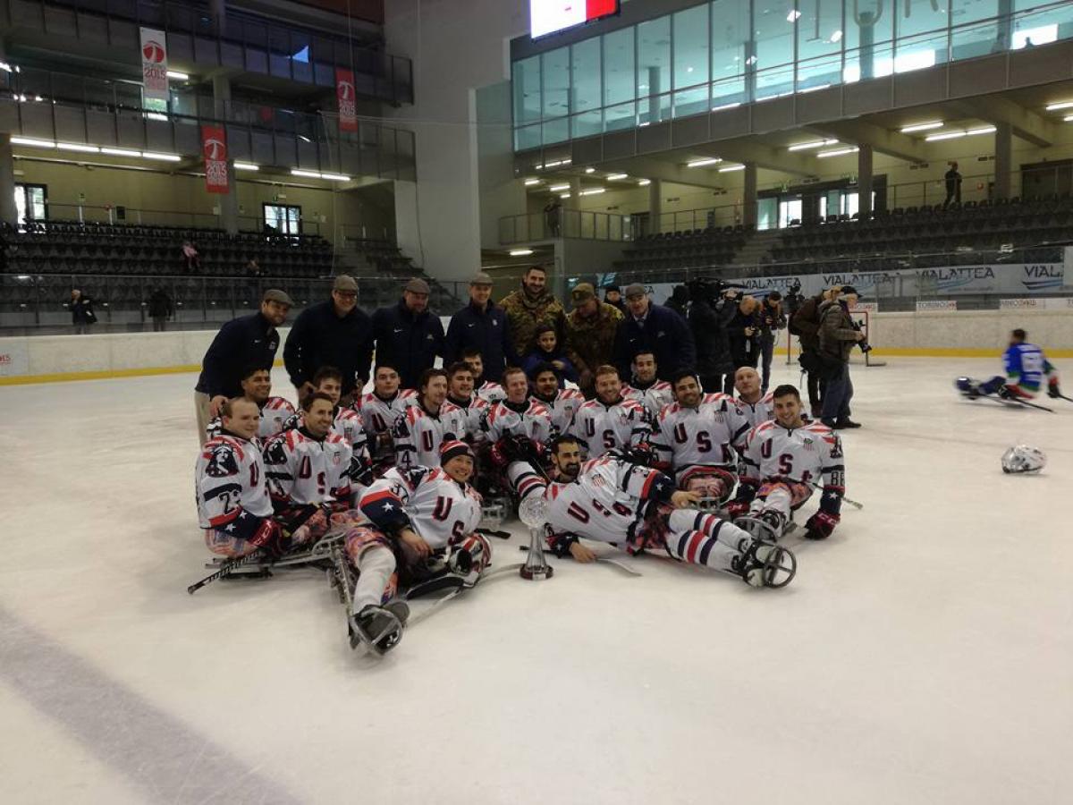 a Para ice hockey team sitting on the ice