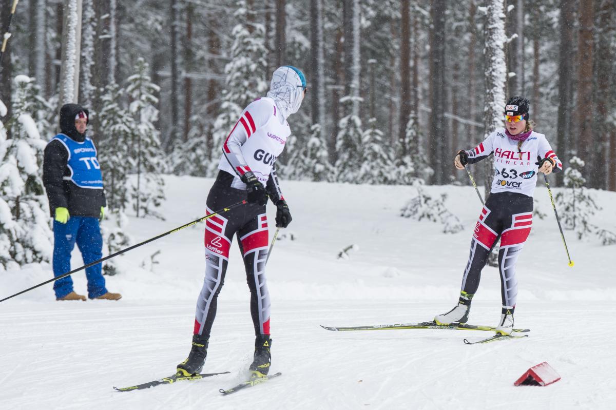 a female vision impaired skier and her guide