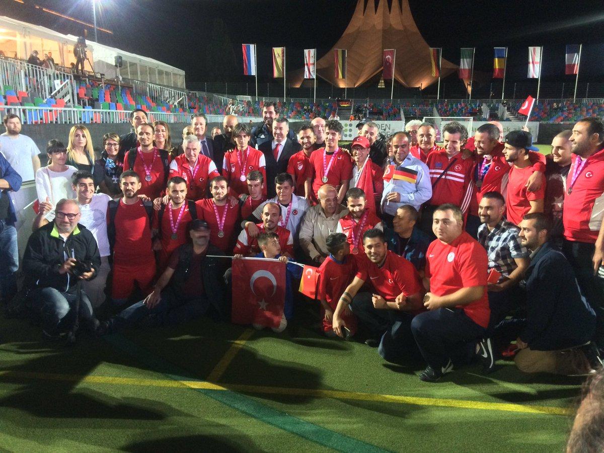 a group of blind footballers pose for a photo on the pitch