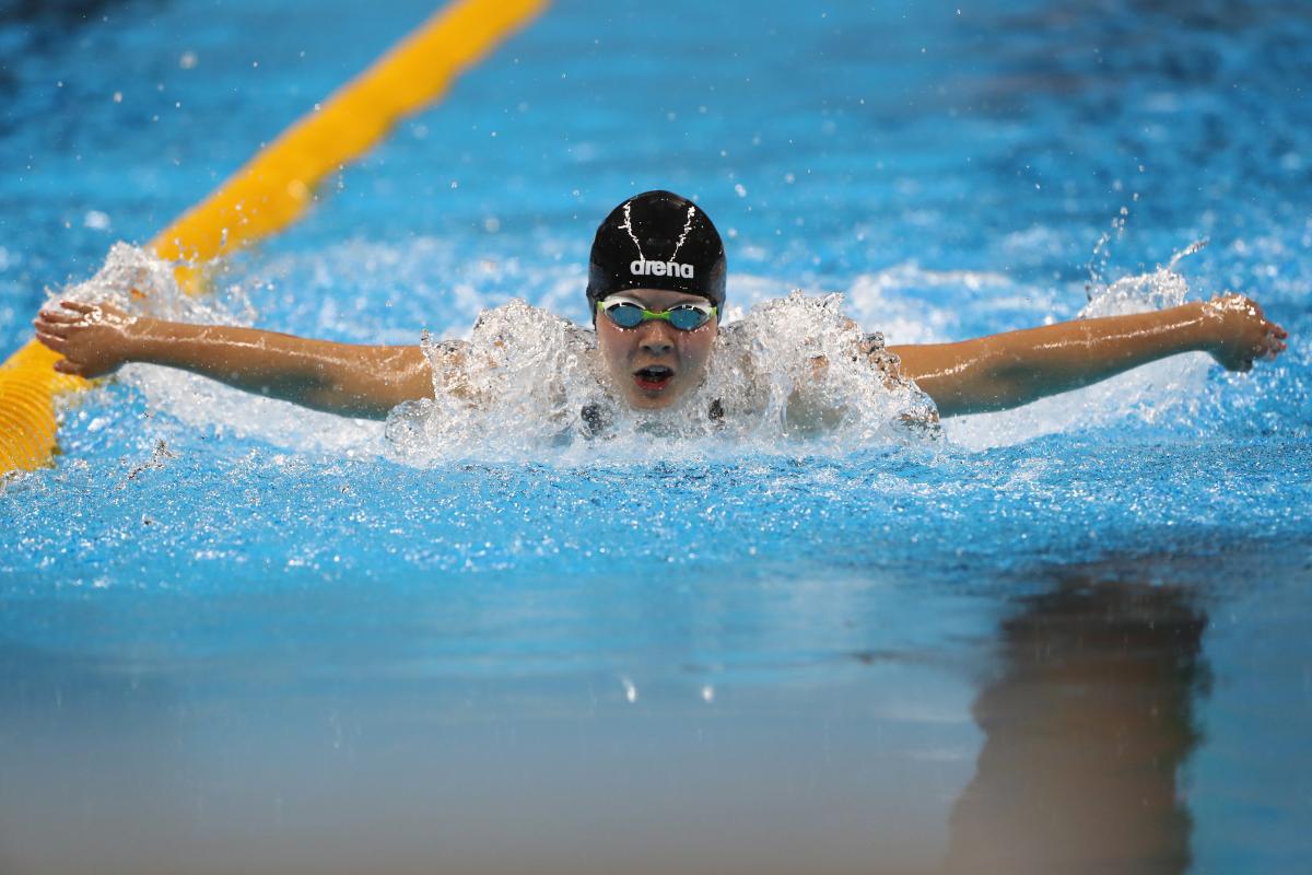 a female Para swimmer mid-butterfly stroke