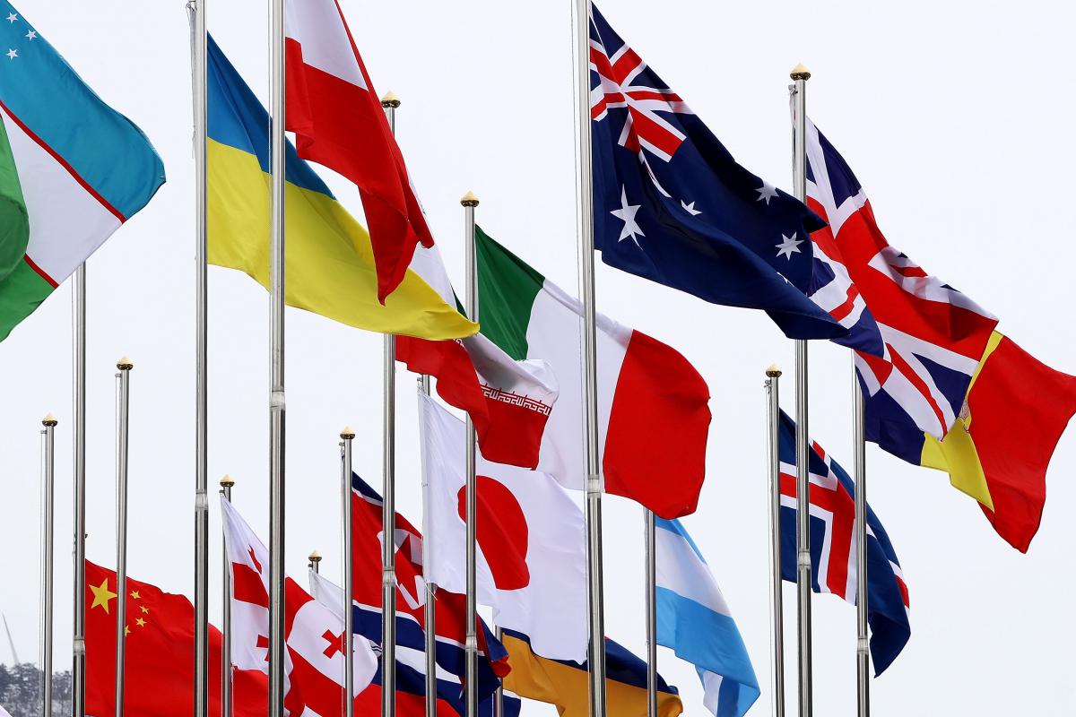 flags from many countries flying in the wind at the Paralympic Village