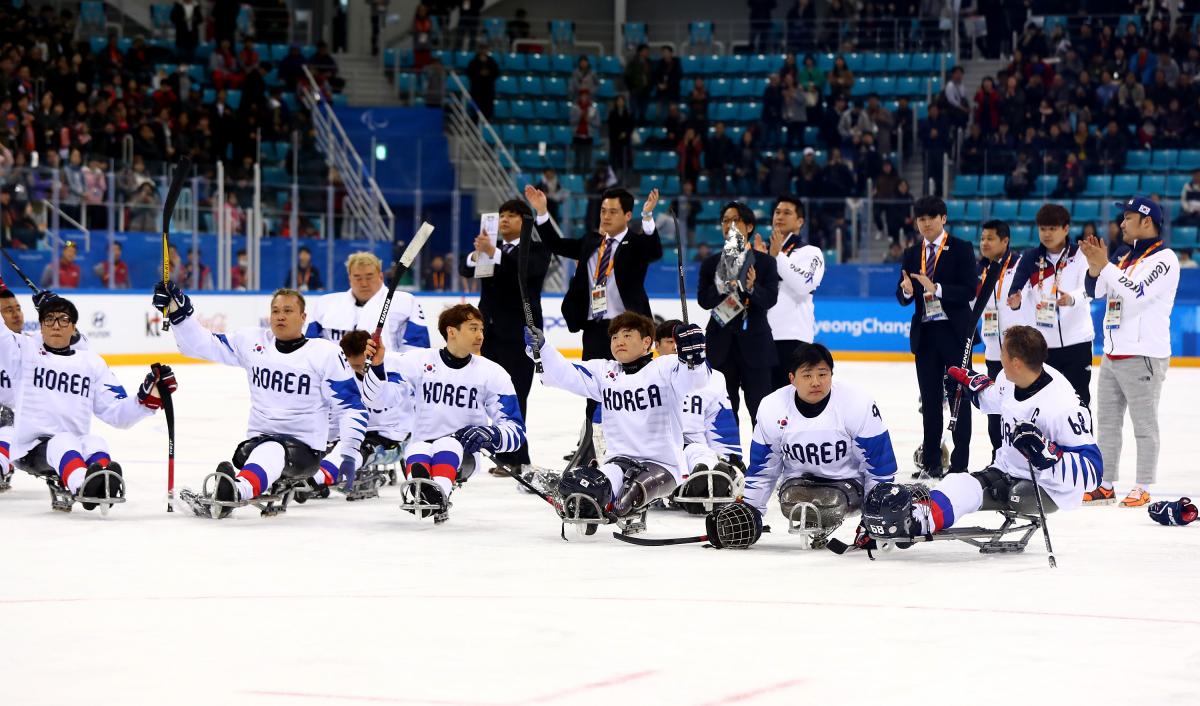 a group of Para ice hockey players on the ice