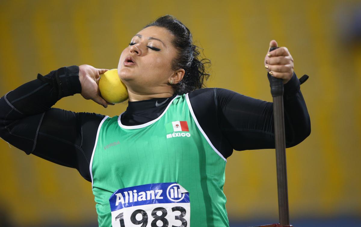 a female shot putter prepares to throw