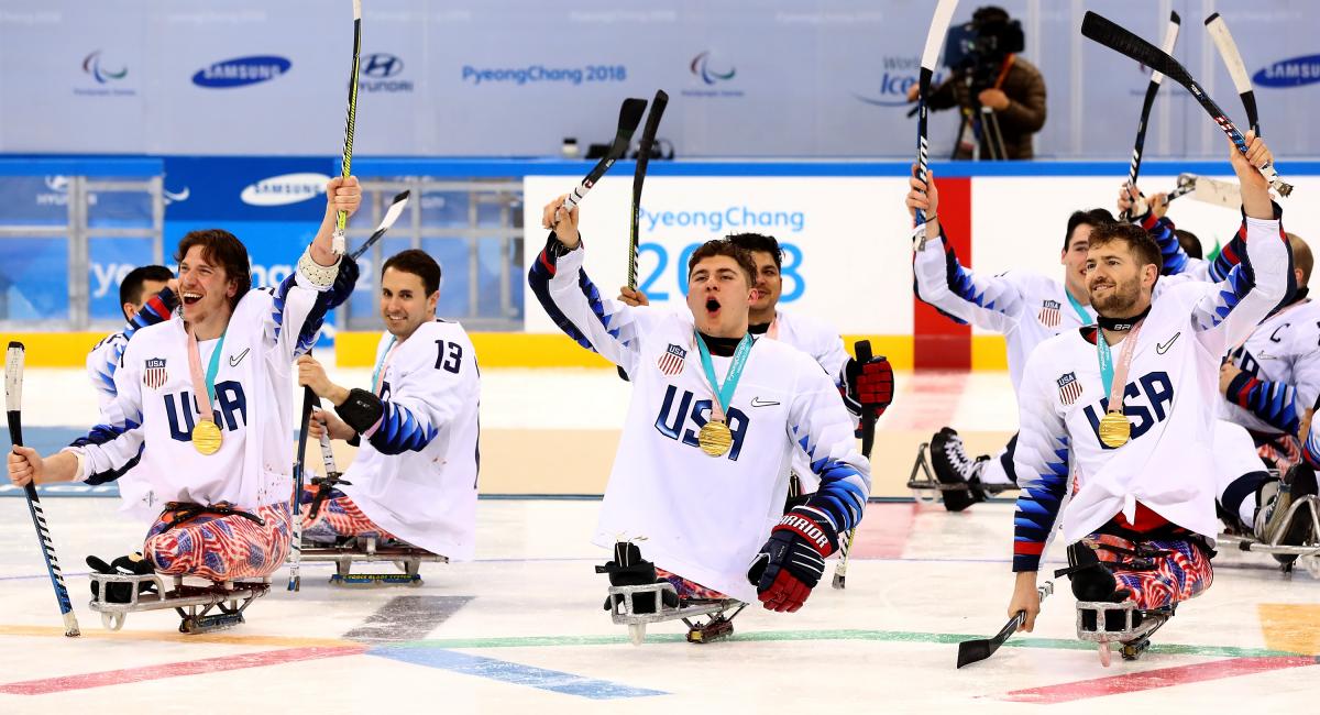 Para ice hockey players celebrating on the ice