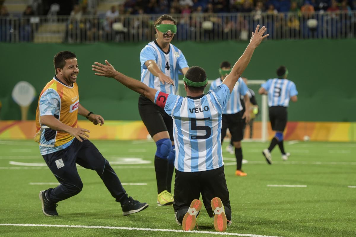 a blind footballer celebrates on his knees