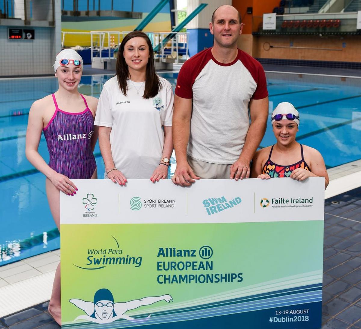 Four people standing showing a big ticket for the Dublin 2018 Para Swimming Euros