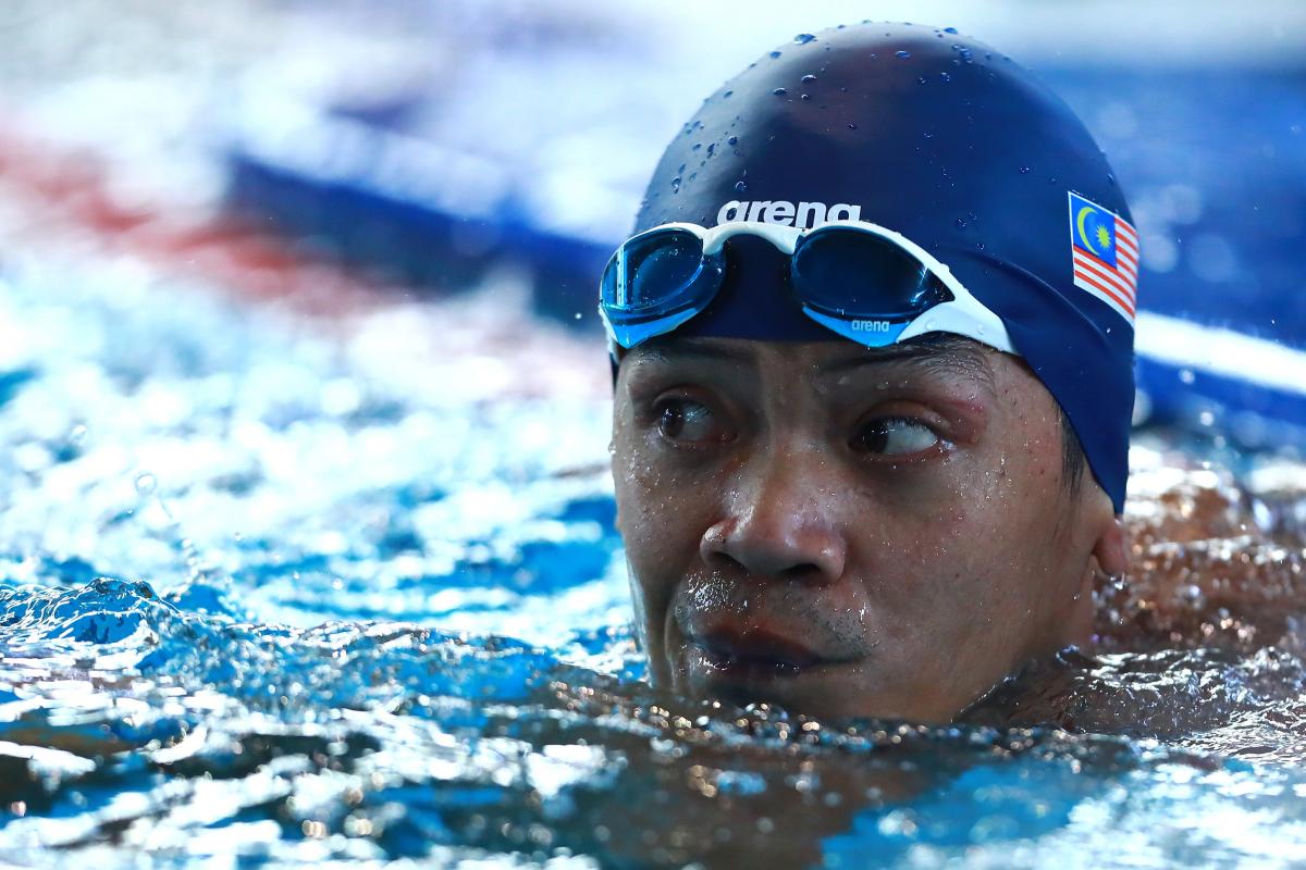 a male Para swimmer in the water