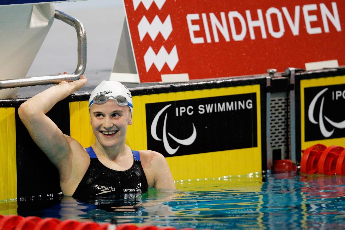 Woman in a swimming pool smiling