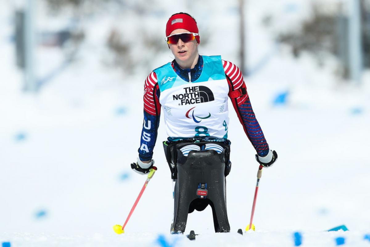 US female Nordic skier pushes on the snowy course