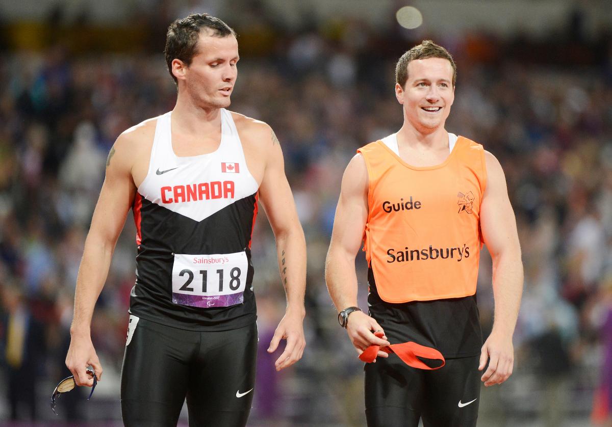 Vision impaired sprinter alongside his guide runner