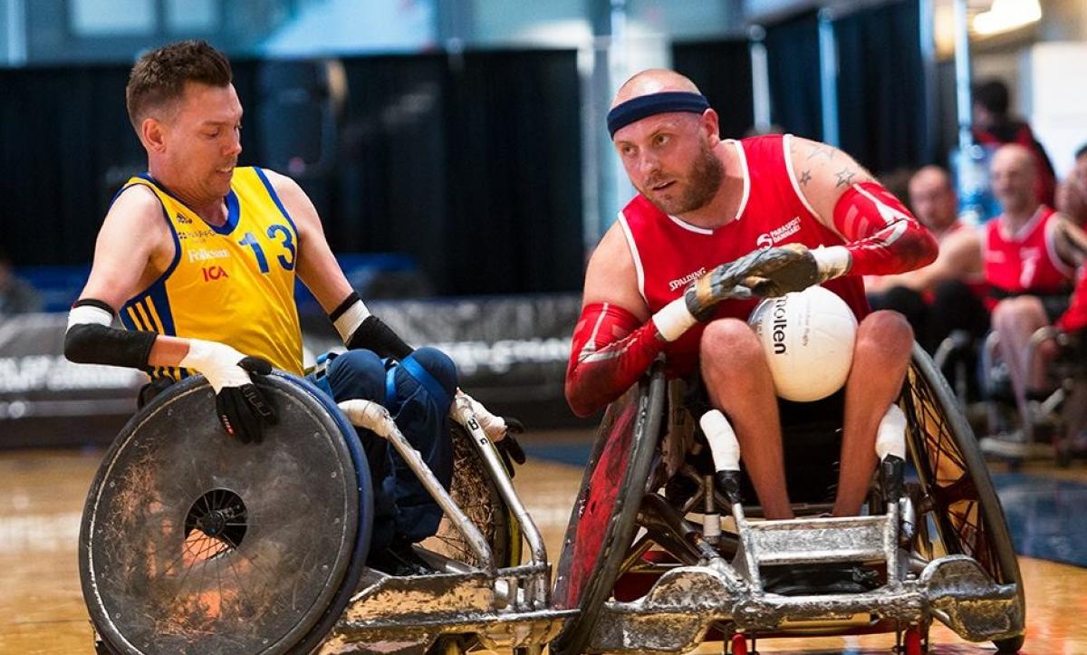 male wheelchair rugby player Stefan Jansson tackles another player