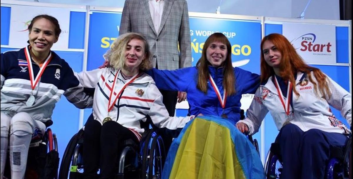 four female wheelchair fencers on the podium with Anastasia Kastsiuchkova on the right