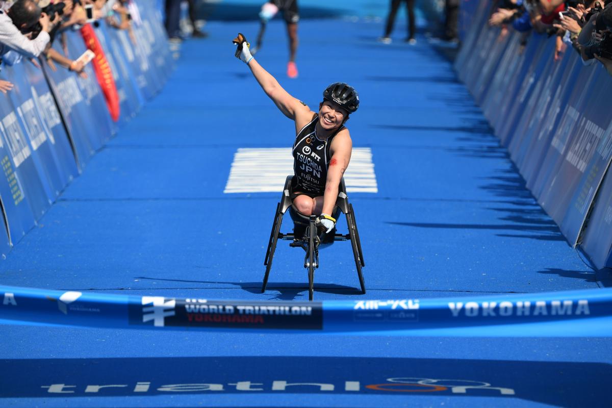 Japanese female Para triathlete Wakako Tsuchida punches the air as she crosses the finish line