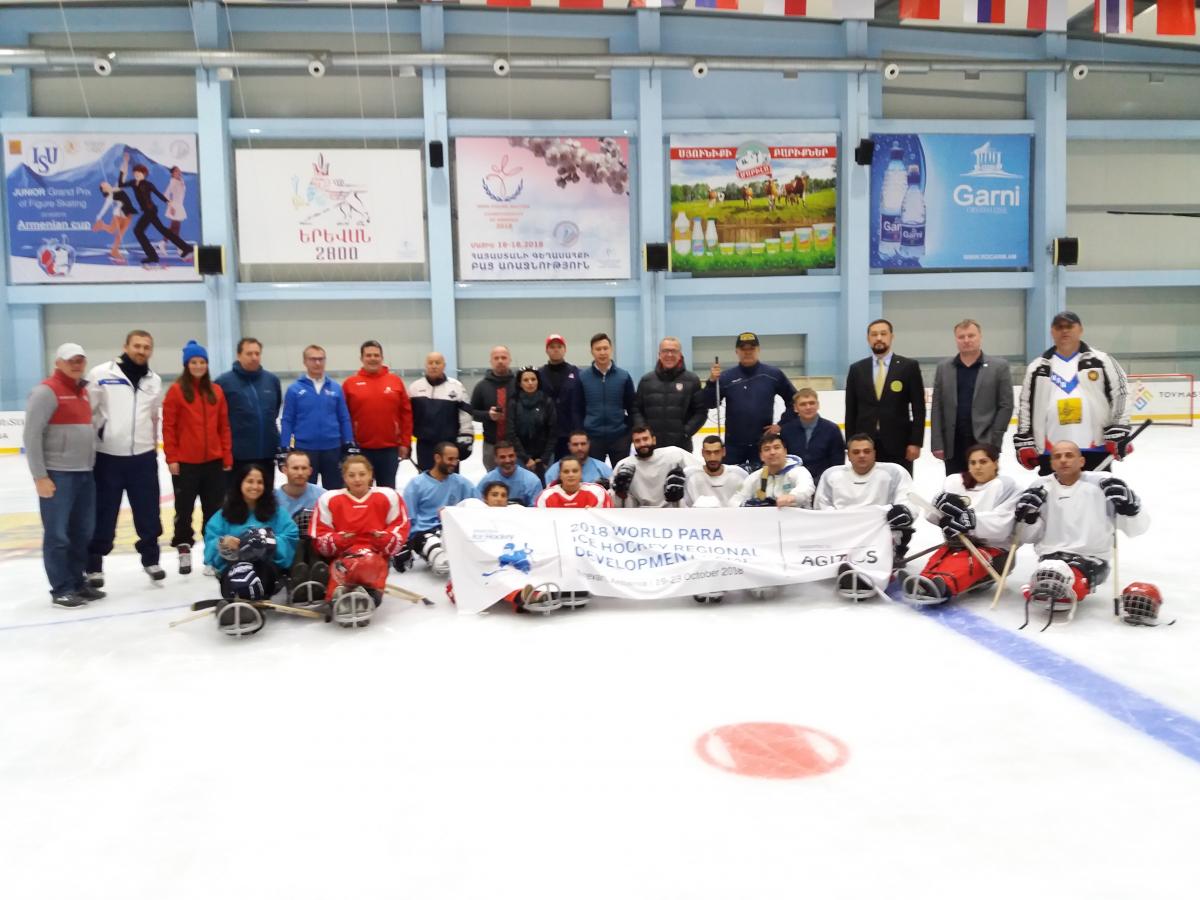 A group of people on sledges on an ice hockey rink