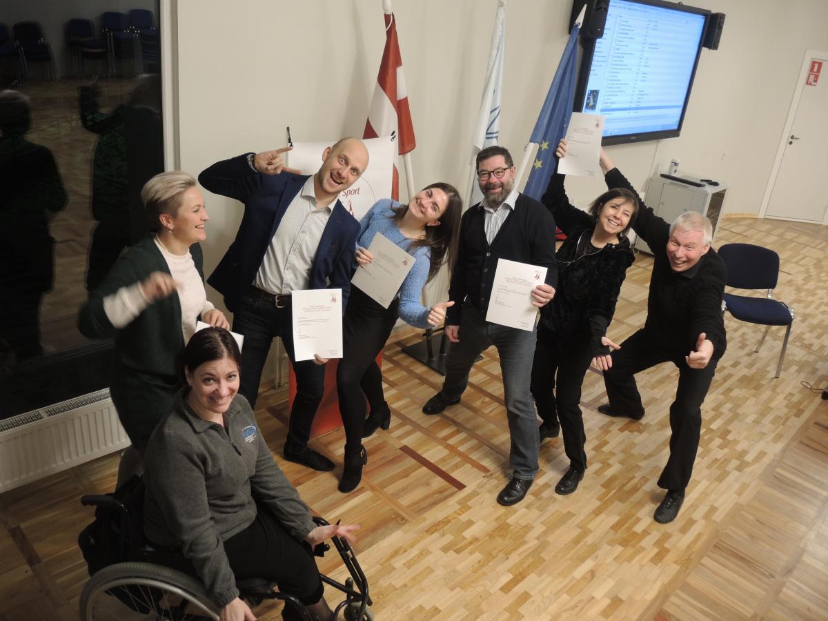 a group of Para dancers and officials giving thumbs up 